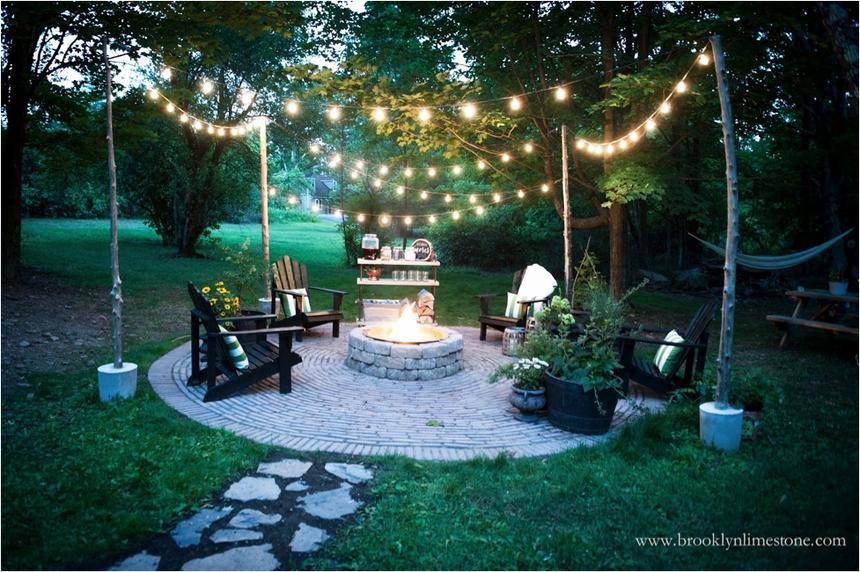 An outdoor patio with a firepit at dusk