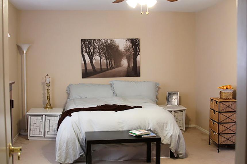 Dark master bedroom with beige walls