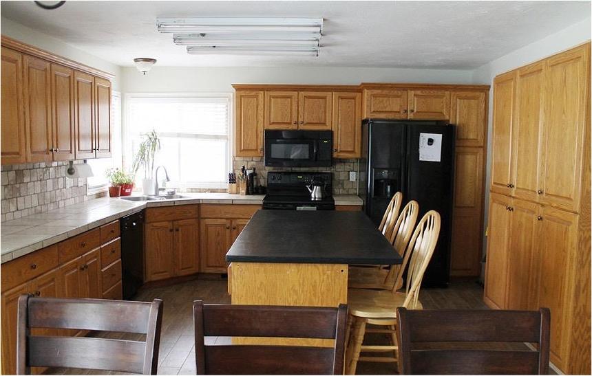 Outdated kitchen with wood cabinetry