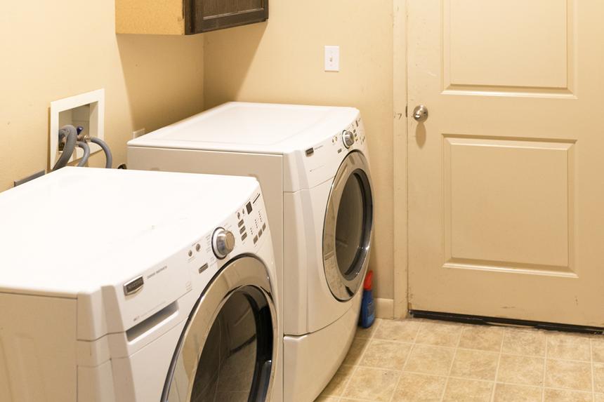 Beige laundry room with outdated beige tile
