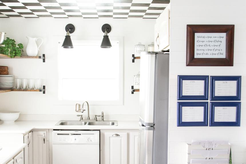 White kitchen with wood floors, white and black ceiling