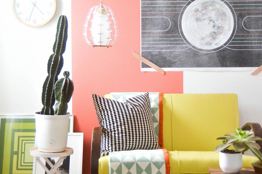 A living room with a white wall and a painted coral line